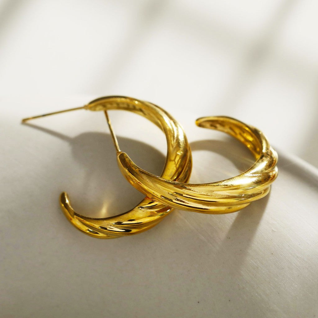 Boucles d'oreilles créoles dorées DORSINA à lignes texturées. Inspirées par la nature.