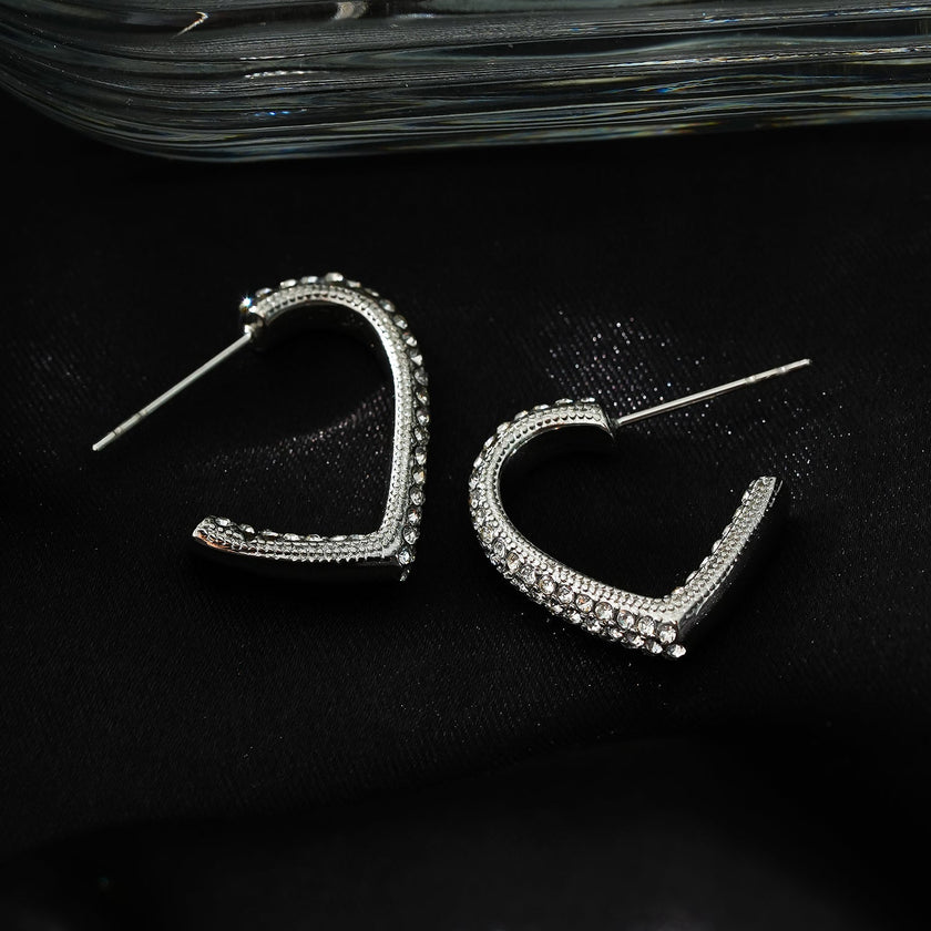 Style ANJAR Or Blanc (Ton Argent) : Boucles d'oreilles en forme de cœur serties de pierres précieuses en zircone.