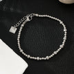 Style ANNABETH : Bracelet chaîne en or blanc (couleur argent) avec double perle en fusion.