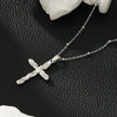 CHAMONIX Or blanc plaqué argent : Collier délicat à maillons perlés avec pendentif croix texturé incrusté de zircons.