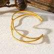Style CHITRA: Industrial-Chic Bracelet with Abstract Shaped Parallel Bands in Gold