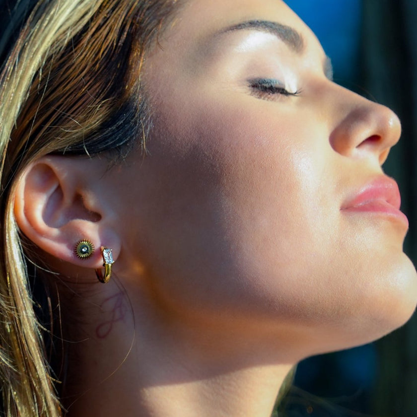 Style CONWYN: Retro Style Hoops with an Encased Clear Zirconia Charm in Gold.