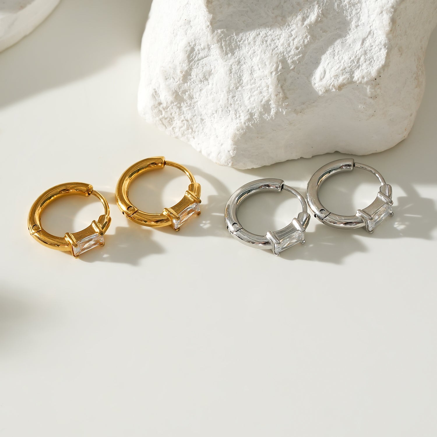 Style CONWYN: Retro Style Hoops with an Encased Clear Zirconia Charm in Silver.