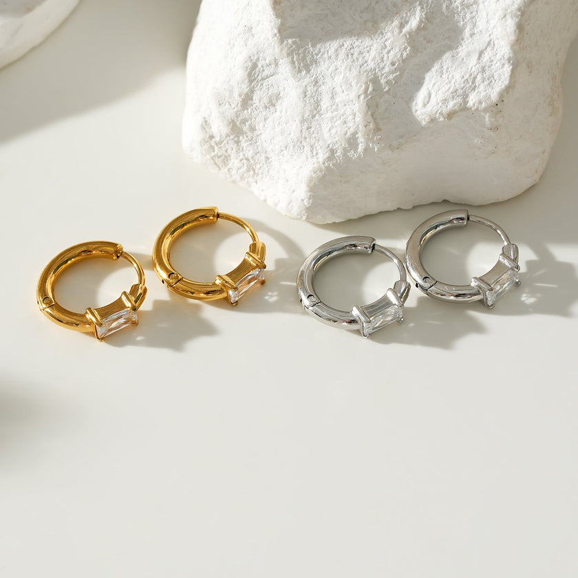 Style CONWYN: Retro Style Hoops with an Encased Clear Zirconia Charm in Silver.