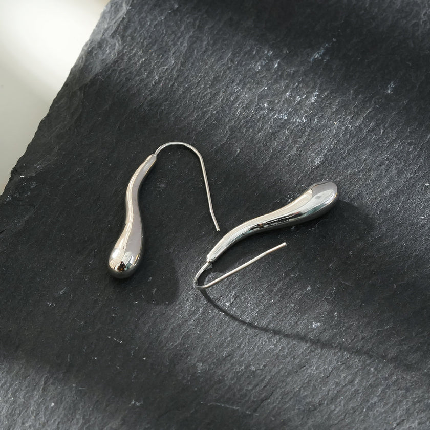 Style CORNING Argent (Or Blanc) : Boucles d'oreilles en forme de têtard – Élégance unique avec une touche ludique.