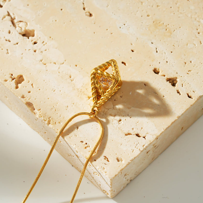 Style KARJAT : Collier à chaîne dorée avec pendentif en zircone géométrique en cage.