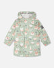 Green raincoat with color-changing frogs