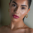 Style KAMENZ: Twisted Textured Hoop Earrings with Zirconia Embellishments.