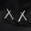 LINDSBORG: Criss-Cross Geometric Stud Earrings in White Gold (Silver Toned)