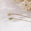 Collier MALVINA en chaîne dorée mixte avec pendentif étoile sertie de zircons.