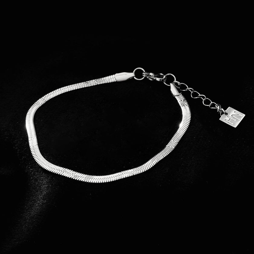 MUKER : Bracelet en chaîne argentée texturée effet peau de serpent avec motif étoile en relief.