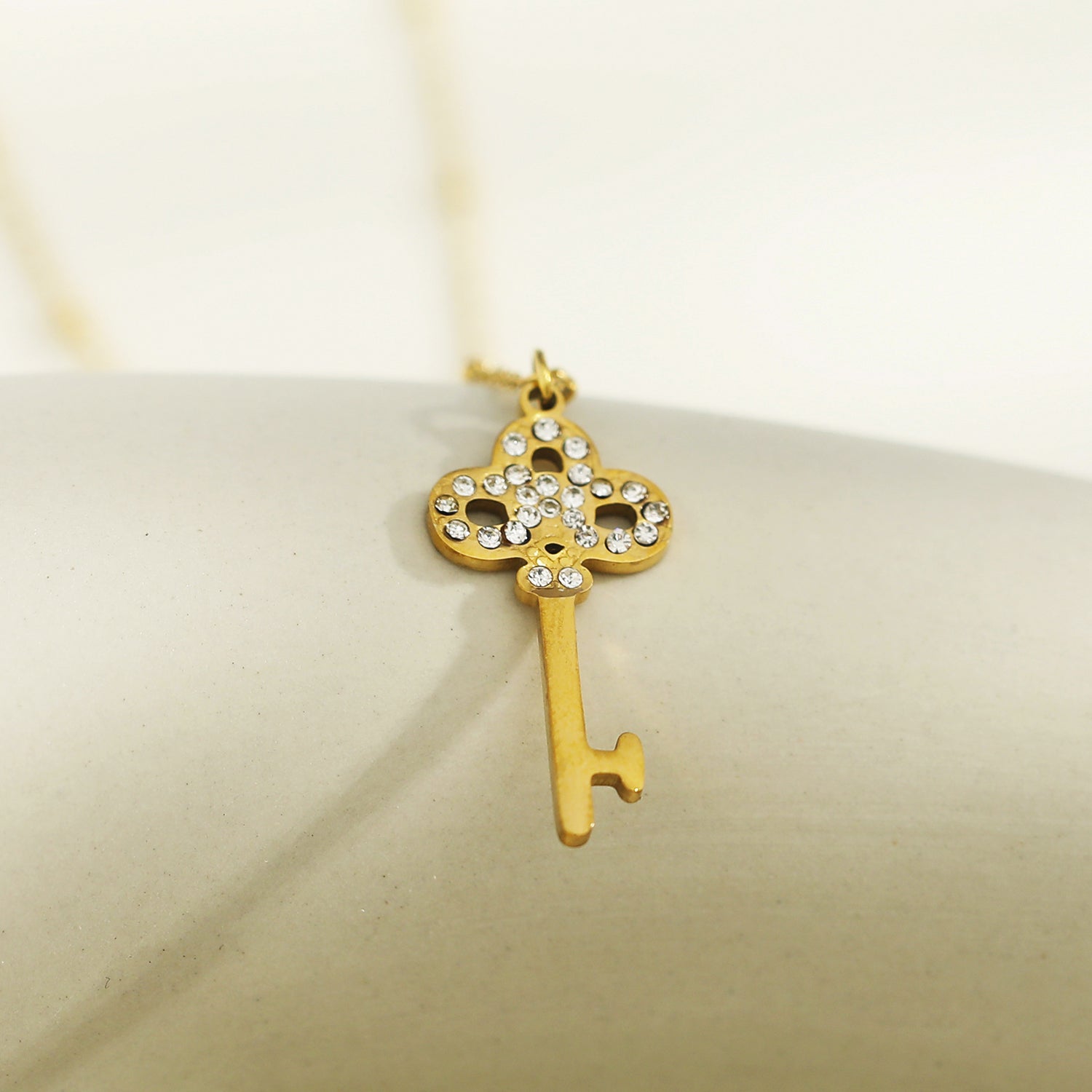 Collier UNLOK en or perlé avec pendentif clé orné de zircons.