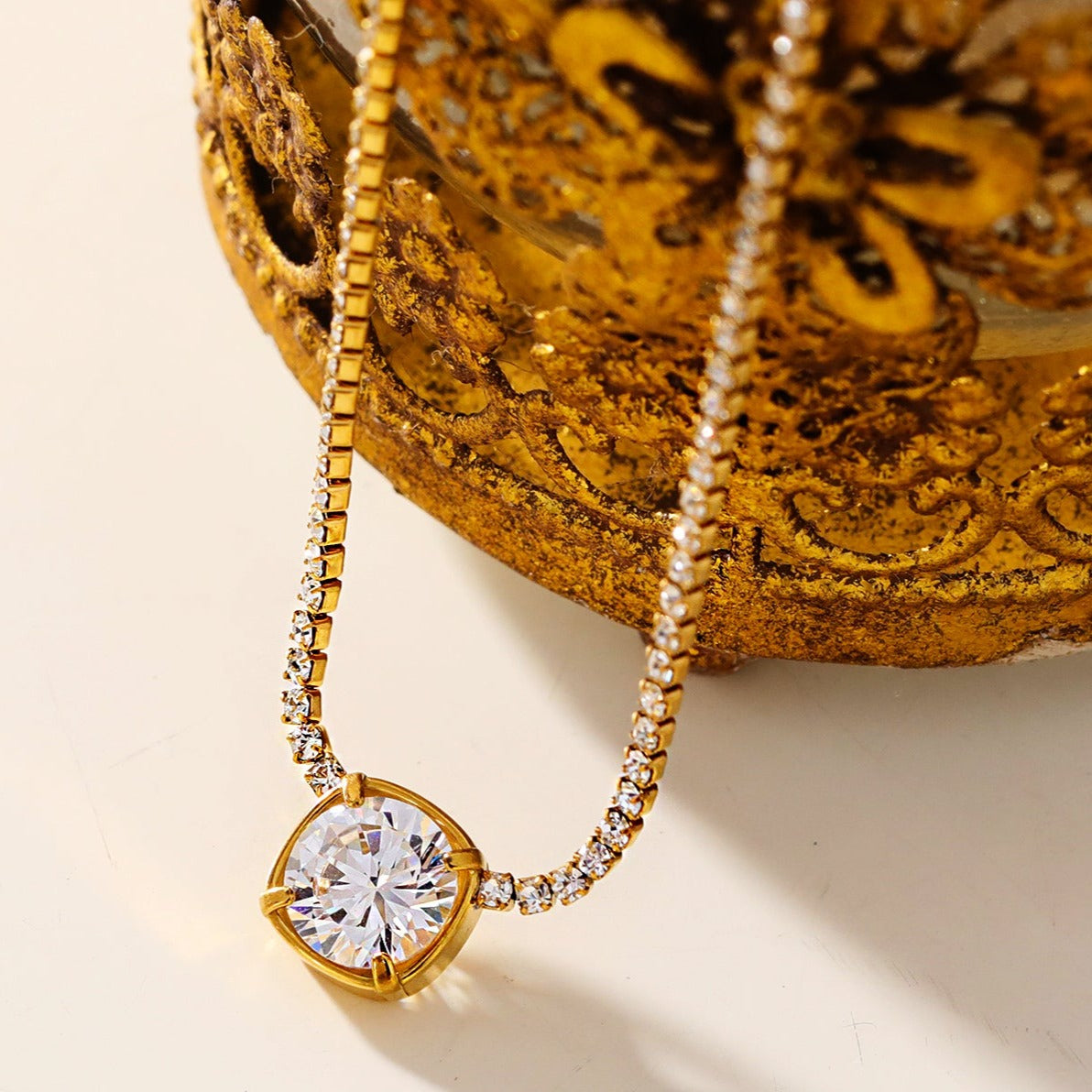 AURA : Collier avec pendentif en zircone serti dans un cadre sur une chaîne à perles de mini-zircone.