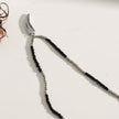 Collier RITA à chaîne perlée noir et argent avec pendentif dent en argent gravé.