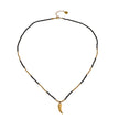Collier RITA à chaîne perlée noir et or avec pendentif dent en or gravé.