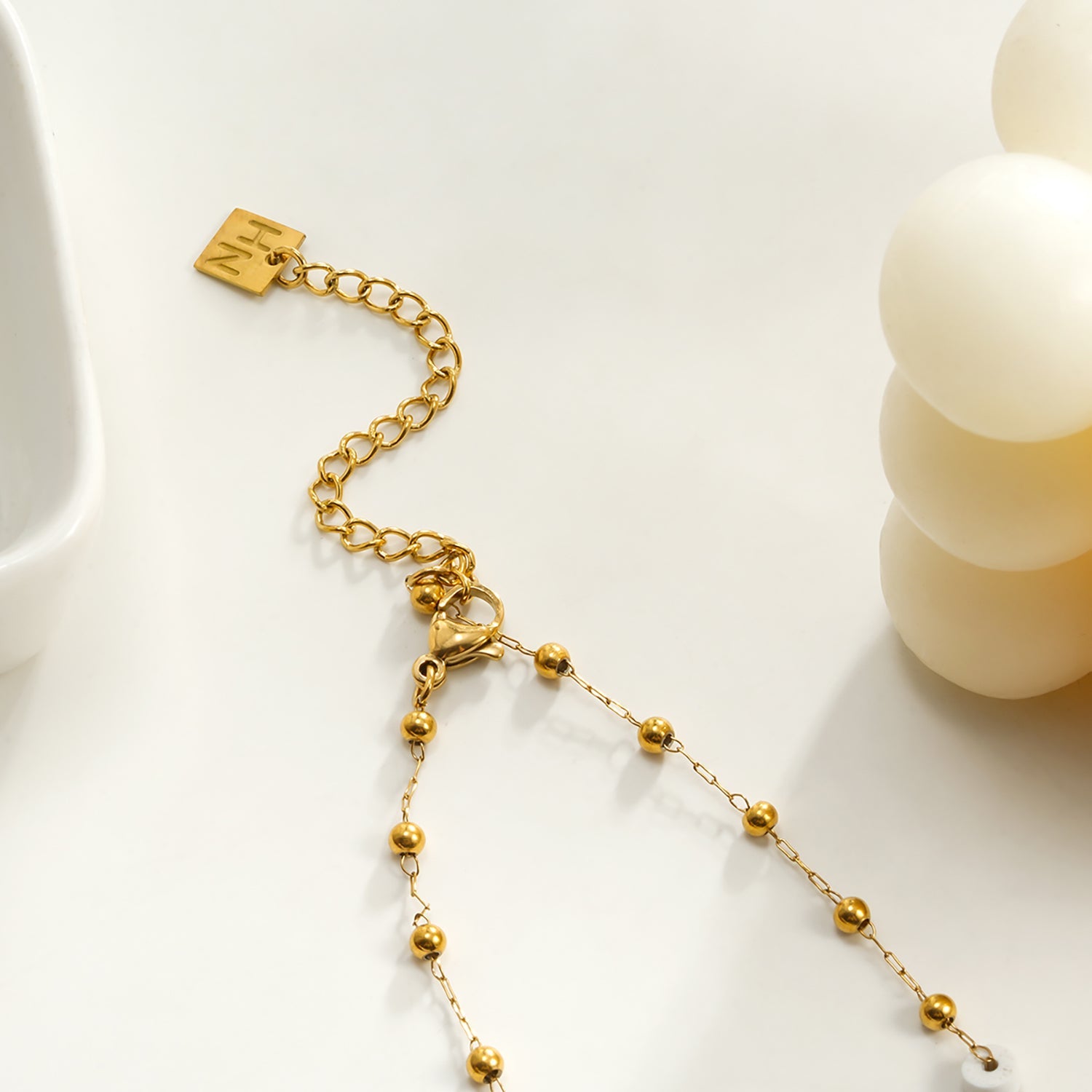 SANTA CRUZ White : Collier chaîne avec perles dorées et pierres blanches.