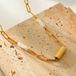 Collier SEDONA : Association de coquillages naturels et de chaîne à maillons dorés, avec un pendentif Art Déco.