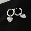 STOWE Silver: Mini Hoop Earrings Anchoring a Heart Shaped Charm