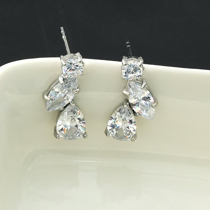 THEOLA : Boucles d'oreilles créoles en forme de pile de trois moissanites, effet éclatant, en or blanc argenté.