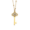 Collier UNLOK en or perlé avec pendentif clé orné de zircons.