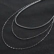 Collier ZURI à trois rangs de chaînes mixtes en argent.