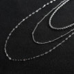 Collier ZURI à trois rangs de chaînes mixtes en argent.